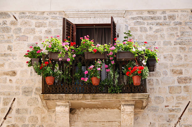 istock Flowers on a balcony in stone wall 471412507
