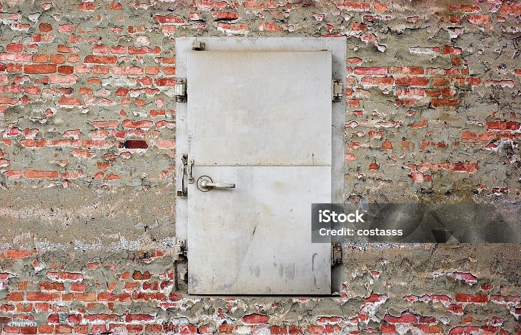 security door on brick wall weathered security door on brick wall Architectural Feature Stock Photo