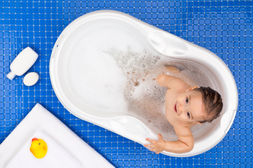 Nine Months Baby Girl in Bathtub with Soap Foam Shot Directly from Above.http://i1215.photobucket.com/albums/cc503/carlosgawronski/BabyGoods.jpg