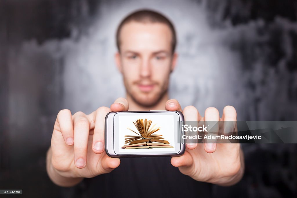 Digital book on smartphone display - E-library concept Explore similar images: Smartphones in action!  Adult Stock Photo