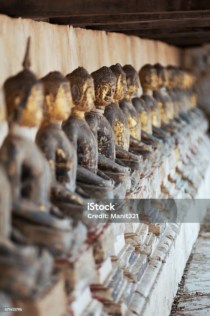 Row of Buddhas statue. Row of ancient buddhas statue at Wat Khanon temple Ratchaburi province Thailand. Generality in Thailand, any kind of art decorated in Buddhist church, temple pavilion, temple hall, monk's house etc. created with money donated by people to hire artist. They are public domain or treasure of Buddhism, no restrict in copy or use, no name of artist appear (but, if there is artist name, it only for tell who is the artist of work, not for copyright). This photo is taken under these conditions. Ancient Stock Photo