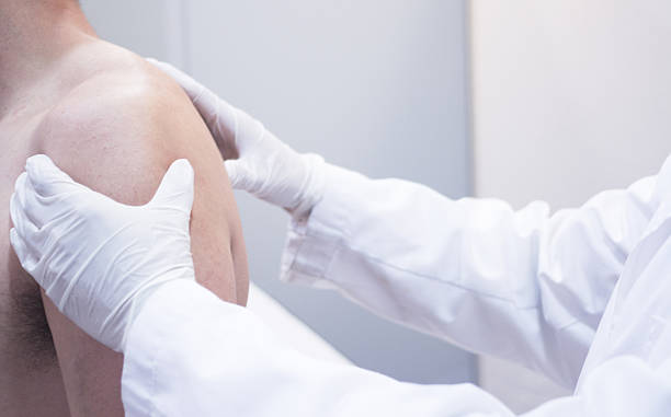 istock Dooctor surgeon examines patient shoulder arm injury 471416158