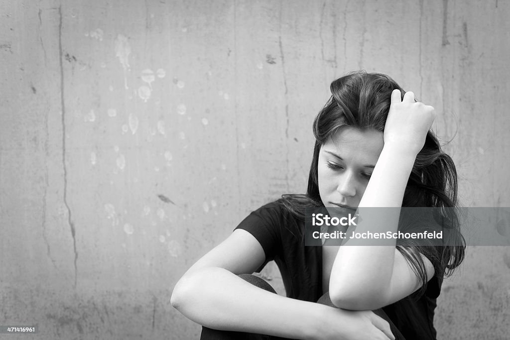 Teenage girl looking thoughtful about troubles Outdoor portrait of a sad teenage girl looking thoughtful about troubles, monochrome photo Depression - Sadness Stock Photo
