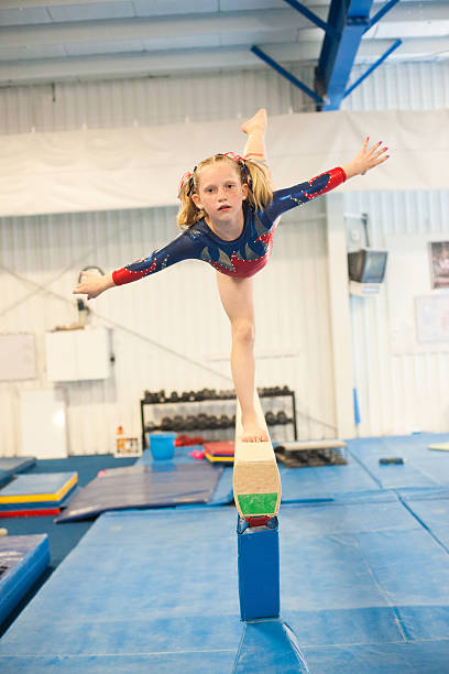 Level five gymnast practicing on beam. stock photo