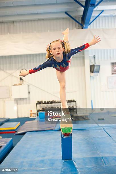 Level Five Gymnast Practicing On Beam Stock Photo - Download Image Now - Child, Gymnastics, Vertical