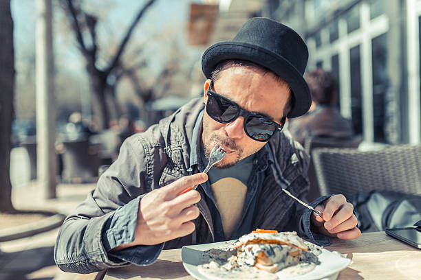 Young man hungry for breakfast at the cafeteria