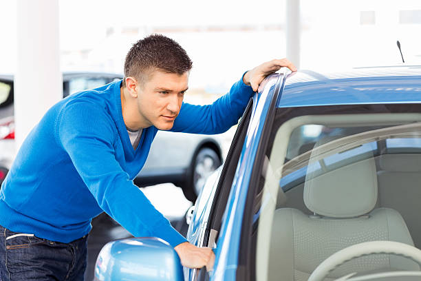 istock Young Man At Car Showroom 471419095