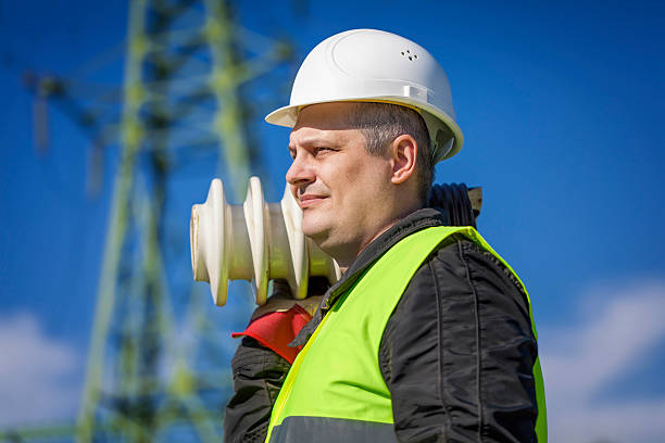 istock Electrician with a damaged insulators 471419926