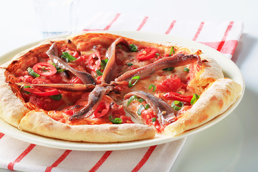 Pizza with anchovies and red pepper