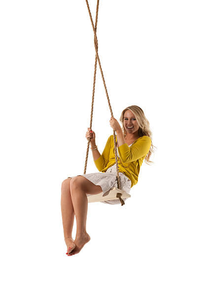 istock Happy attractive young woman posing on a swing 471419987