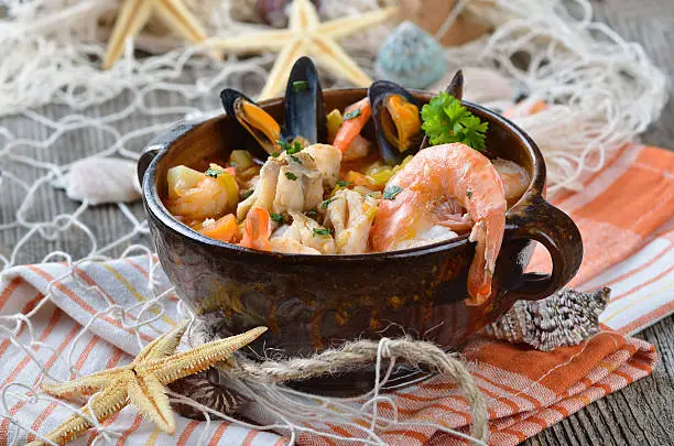 Delicious fish soup with shimps, mussels, fish fillet and vegetables