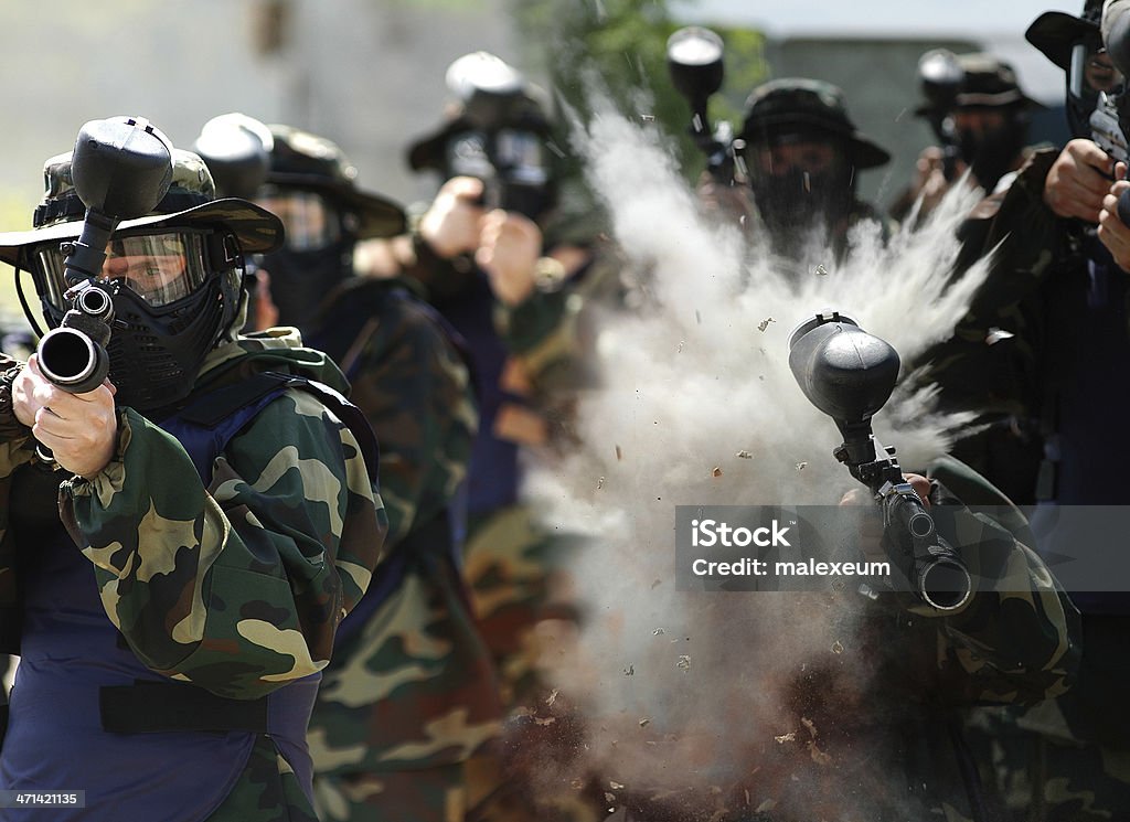 War Games. Direct hit in paintball player. People playing in real paintball. Game in which teams of players simulate a military skirmish. One player has direct injury. Paintballing Stock Photo