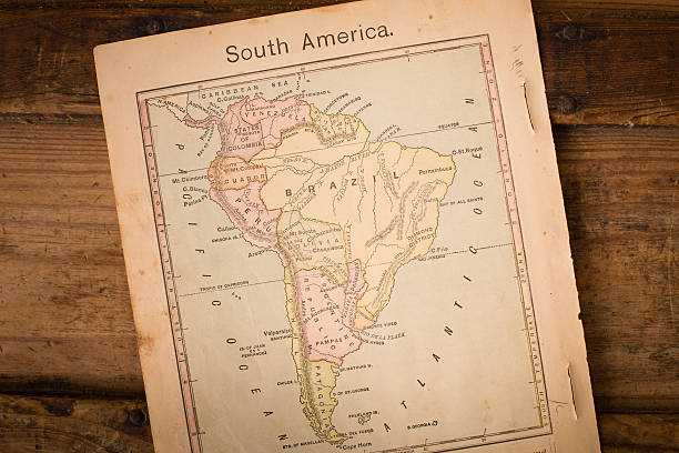 1867, Old Color Map of South America, on Wood Background Color image of an old color map of South America, from the 1800's, sitting slanted on wood background.   topographic map photos stock pictures, royalty-free photos & images