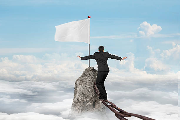 istock Businessman walking on iron chain toward white flag with cloudsc 471426222