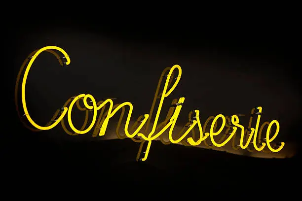 Neon Sign "Confiserie" - Confectionary. Slight reflection on the background adds depth to the image.