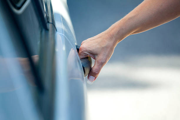 istock Female hand on a car door handle 471427421