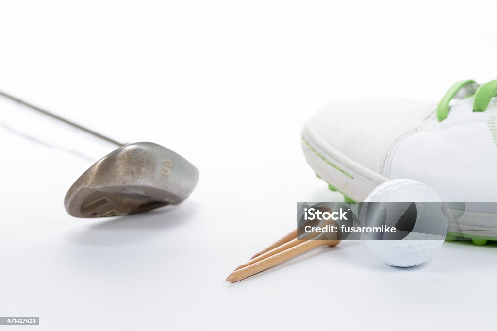 Golf Equiptment Various golf equiptment on a white background. Golf shoe, golf ball, golf wedge, and golf tees. 2015 Stock Photo
