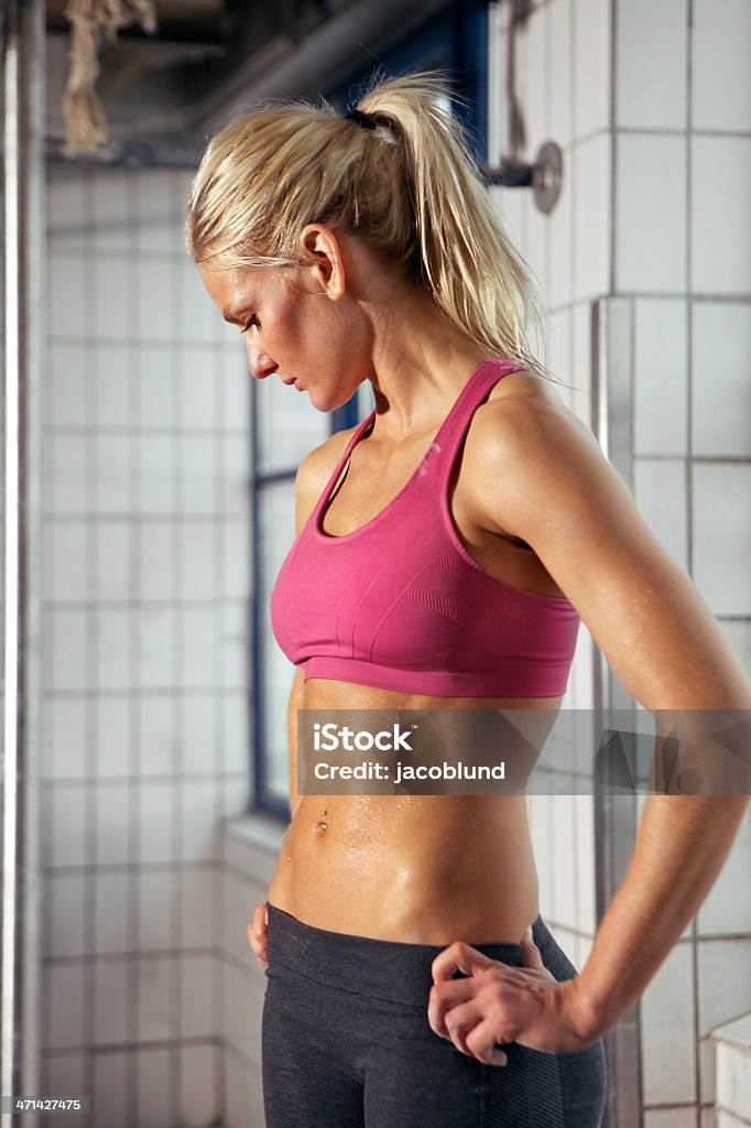 Portrait of Sporty Woman in Gym Portrait of a very fit woman having a break from her workout Adult Stock Photo
