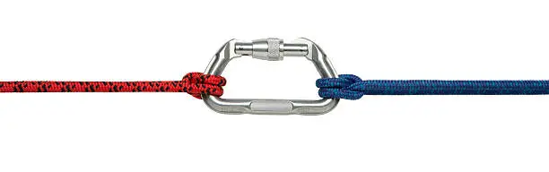 This is a photo taken in the studio of a red and blue climbing rope attached to a carabiner with a clove hitch knot on each end isolated on a white background. There is a clipping path included with this file.