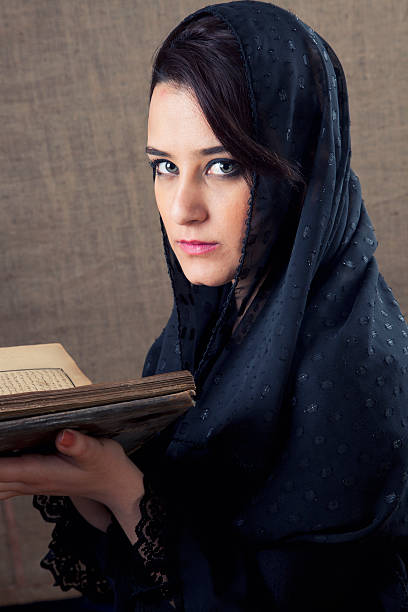istock Muslim Woman Reading the Koran 471428443