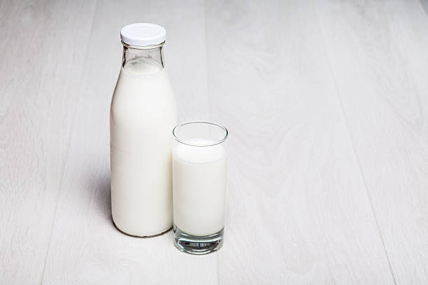 istock milk bottle and glass on wooden background 471429087