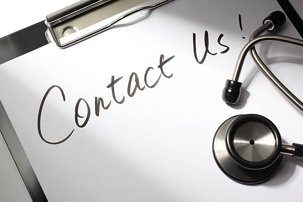 Contact for Medical Help Healthcare concept. "Contact Us!" written on a doctor's clipboard with stethoscope. health symbols/metaphors stock pictures, royalty-free photos & images