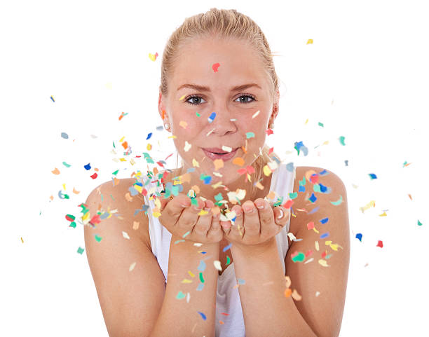 istock Attractive girl playing with confetti 471431551