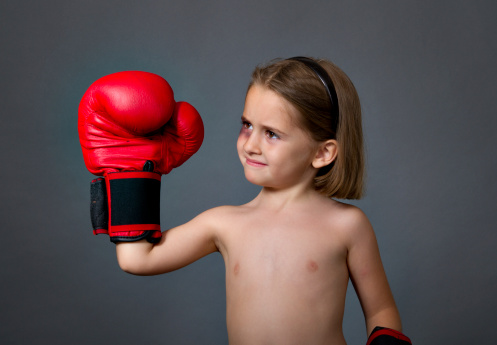 child with boxing gloves, gray background