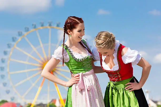 Young women in traditional Bavarian clothes - dirndl or tracht - on a festival or Beer Fest