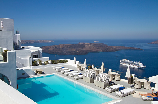 Swimming pool facing the blue sea in Santorini in Greece, one of the most famous place on earth.