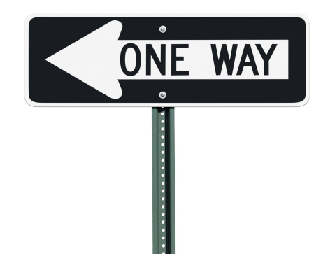 A one way sign over an isolated background pointing to the left.