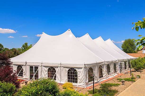 A white event tent in a garden stock photo