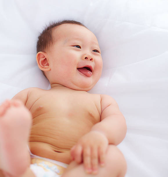 istock lovely baby lying in bed 471435563