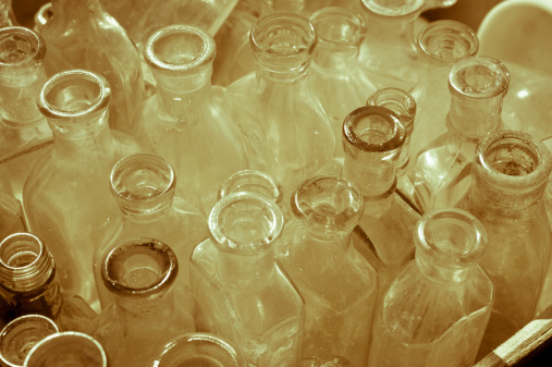 Top-view of antique bottles for sale at a fleamarket, toned sepia