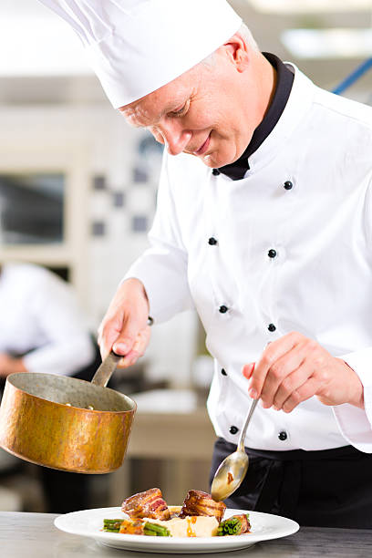 istock Chef in kitchen smiling at the high quality meal he prepared 471436205
