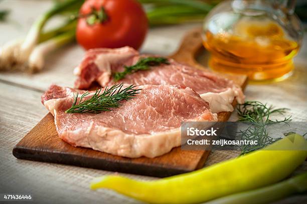 Raw Meat On The Chopping Board With Various Vegetables Stock Photo - Download Image Now