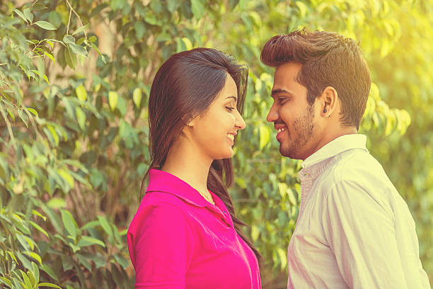 istock Young Couple Romancing In a Park 471436530