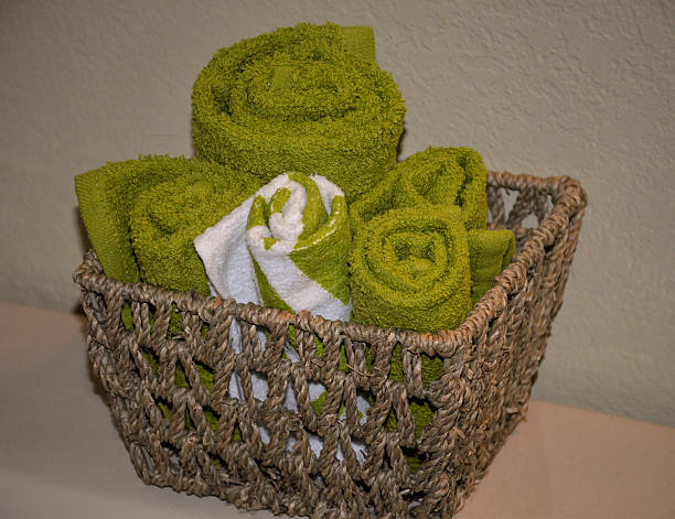 istock Green Towels in a woven basket 471436542