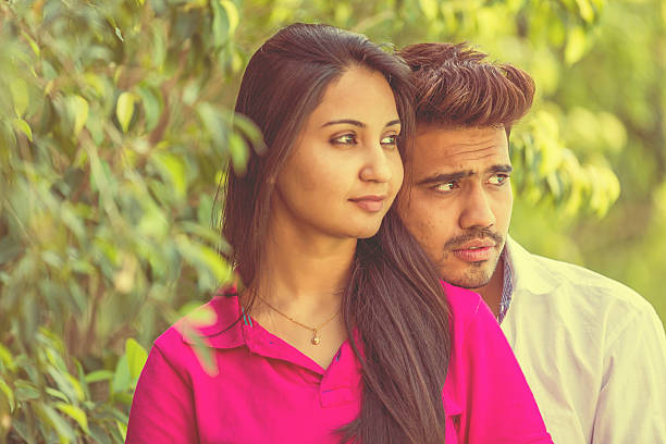 istock Young Couple Romancing In a Park 471436546
