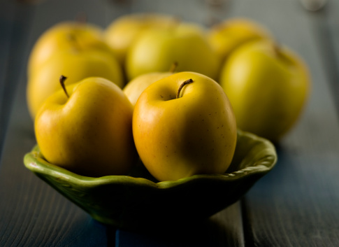 Juicy and ripe golden apples still life under natural lighting