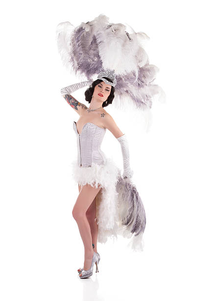Burlesque female dancer with white and gray feathers Burlesque dancer performing burlesque show with stage costume, isolated on white. vintage of burlesque dancers stock pictures, royalty-free photos & images