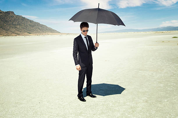 istock Young businessman with umbrella 471439077