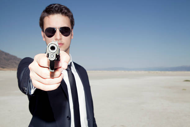 istock Businessman aiming a handgun 471439123