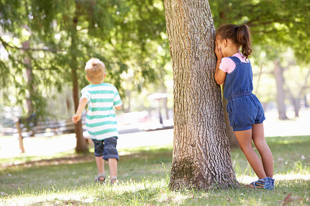 istock Two Children Playing Hide And Seek In Park 471439701