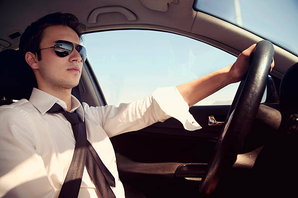 istock Businessman driving a car with sunglasses 471439741