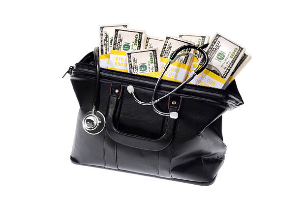 Doctor's Bag Doctor's Bag with stethoscope and money inside on a white background leather medical bag stock pictures, royalty-free photos & images