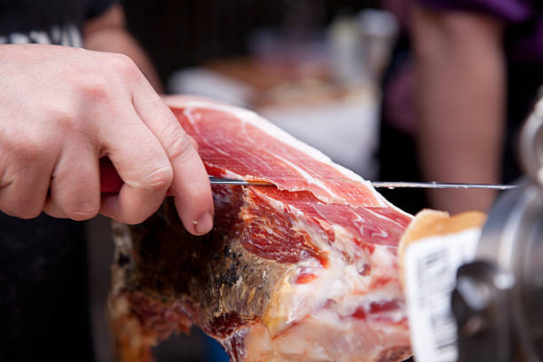 Slicing cured Ham stock photo
