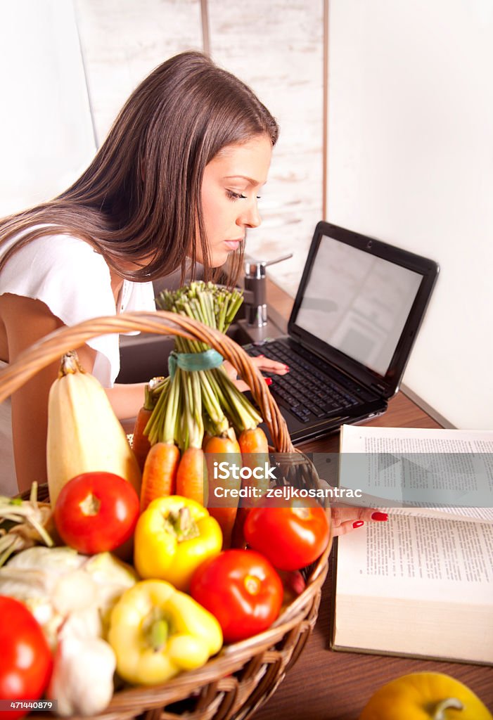 Bella donna cucinare e cercando una ricetta online - Foto stock royalty-free di Adulto