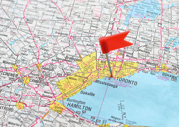 Toronto on the Map Close up of a flag pin marking Toronto, Ontario on an old, generic map.   canada road map stock pictures, royalty-free photos & images