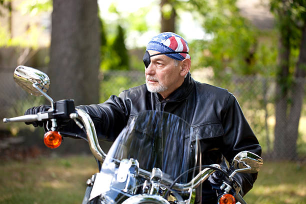 istock Biker in leather jacket, patched eye, beard and tough look 471441887